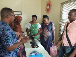 NCIC COORDINATOR, DR. BASIL IBEBUNJO, GIVING NEW INDUCTEE A TOUR OF FACILITIES